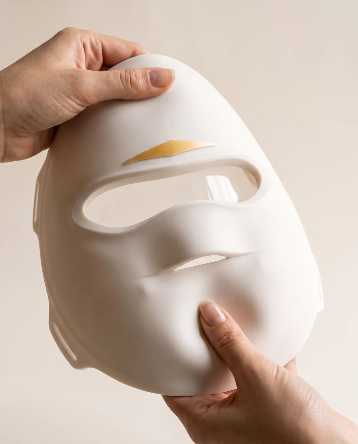 Two hands bending the soft silicone mask